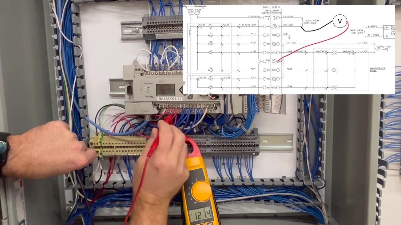 Multimeter probes placed on the output terminal, with the meter reading 0.0V and a schematic overlay visible.