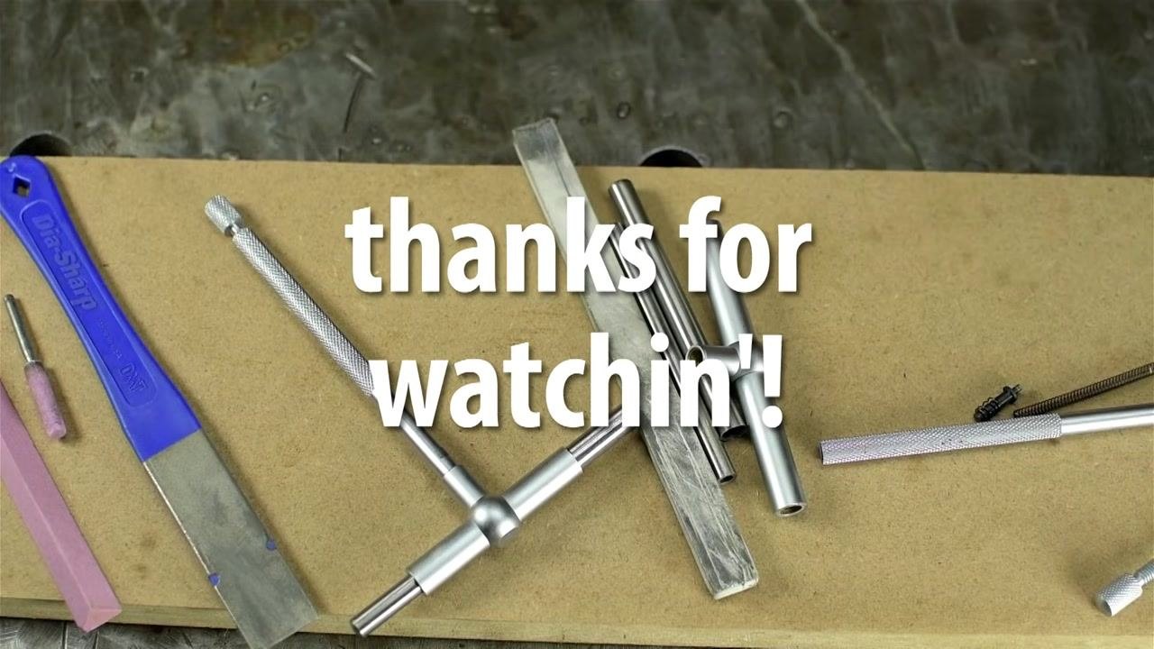 A clean work surface with all tools and finished metal plunger parts neatly arranged. The following items are visible: a blue-handled DMT Dia-Sharp diamond stone, a pink abrasive stick, a small cylindrical grinding stone, several metal tubes and rods, a spring, and an assembled T-handle tool. Large white text over the image reads "thanks for watchin'!"