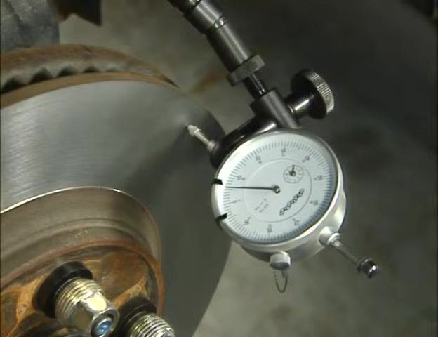 Close-up of the dial indicator gauge with the needle set at zero, confirming the zero setting.
