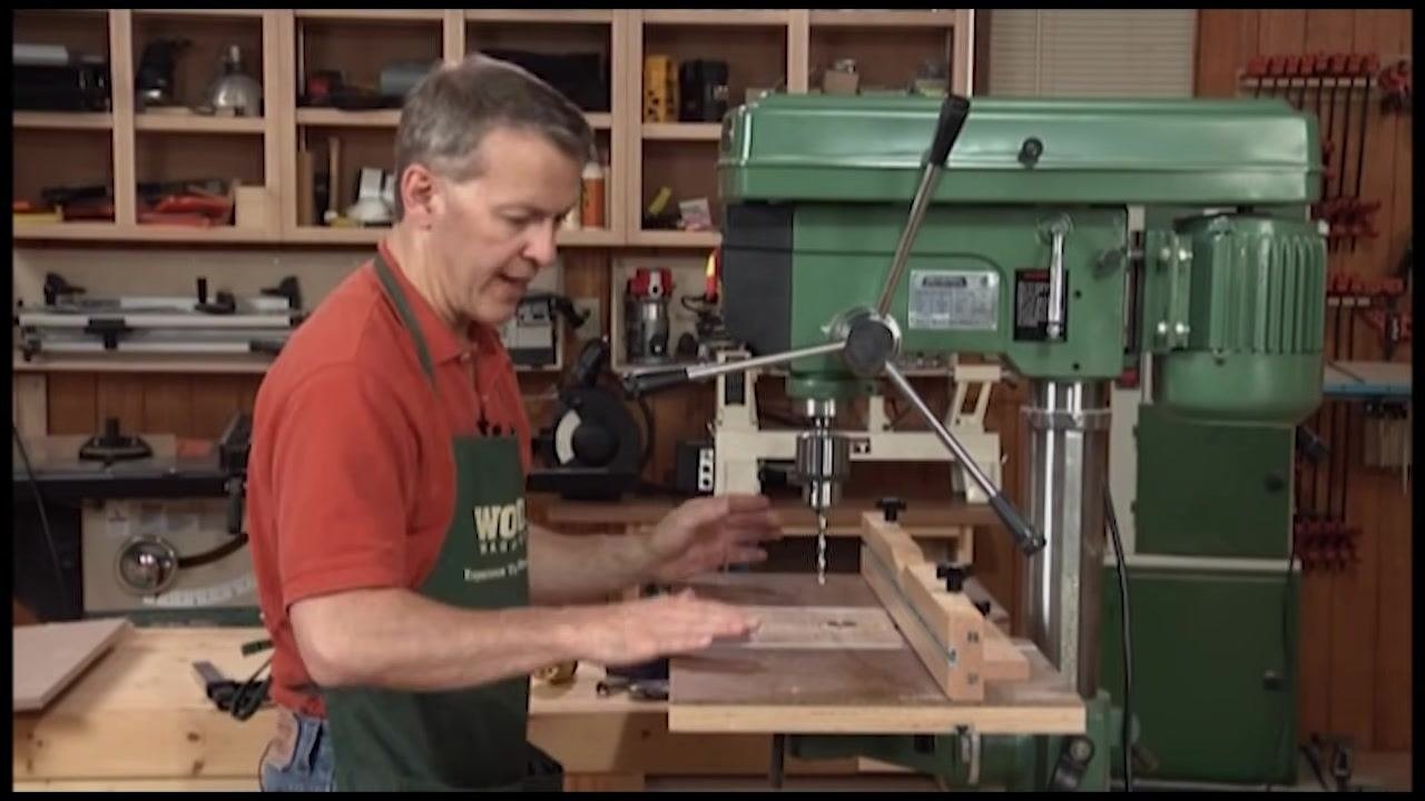 Large woodworking drill press table with fence and accessories installed on the drill press