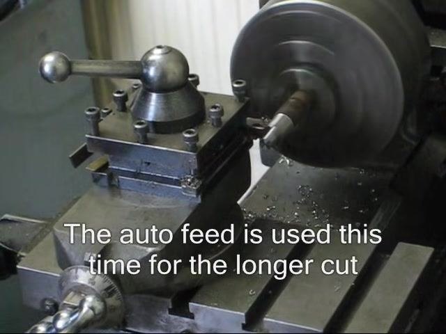 Lathe continuing the auto feed cut, with the workpiece spinning steadily.