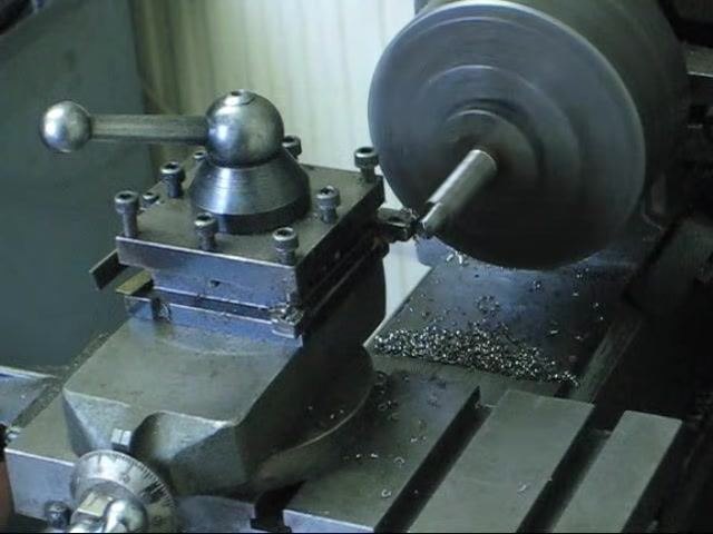 Lathe running with the workpiece spinning and the cutting tool retracted after the pass.
