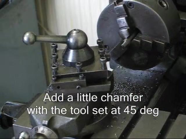 Lathe stopped with the chamfered workpiece and 45-degree tool visible.