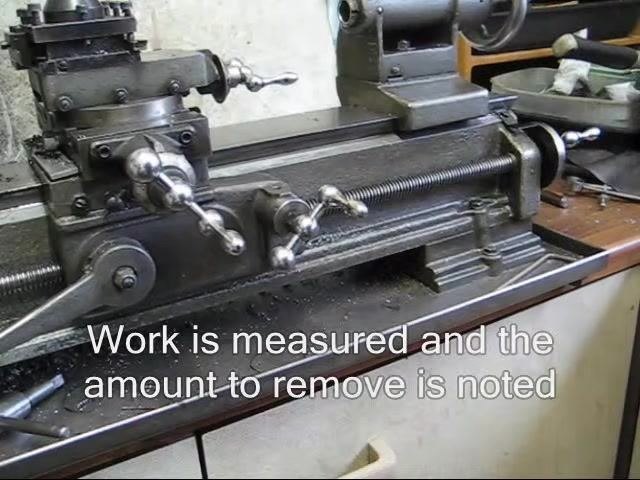 Technical drawing positioned alongside the lathe setup for reference during facing.