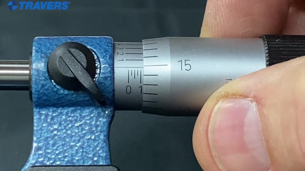Micrometer with the "1" mark on the sleeve and the "15" on the thimble aligned with the reference line, indicating 0.115 inches.