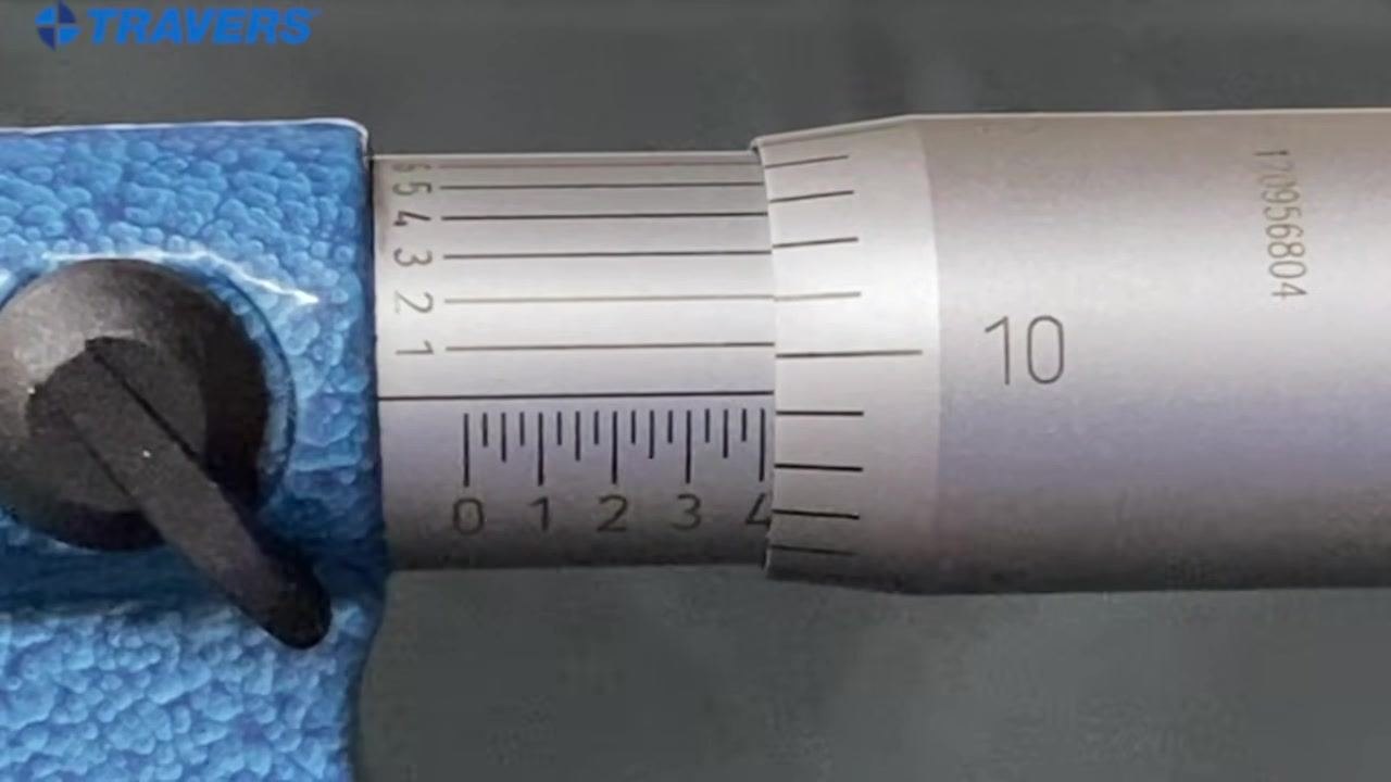 Micrometer close-up with the sleeve and thimble scales clearly visible and no pen present.