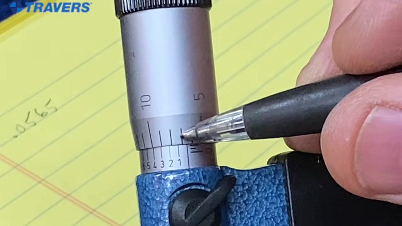 Close-up of a micrometer with a pen pointing at the number 5 on the vernier scale, which aligns with the main scale while the number 4 does not.