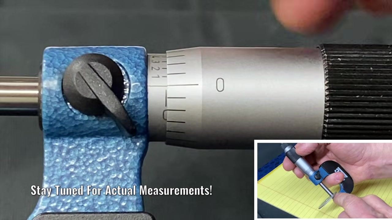 Micrometer close-up with the thimble at zero and a small line on the sleeve visible, indicating the 25-thousandths position.