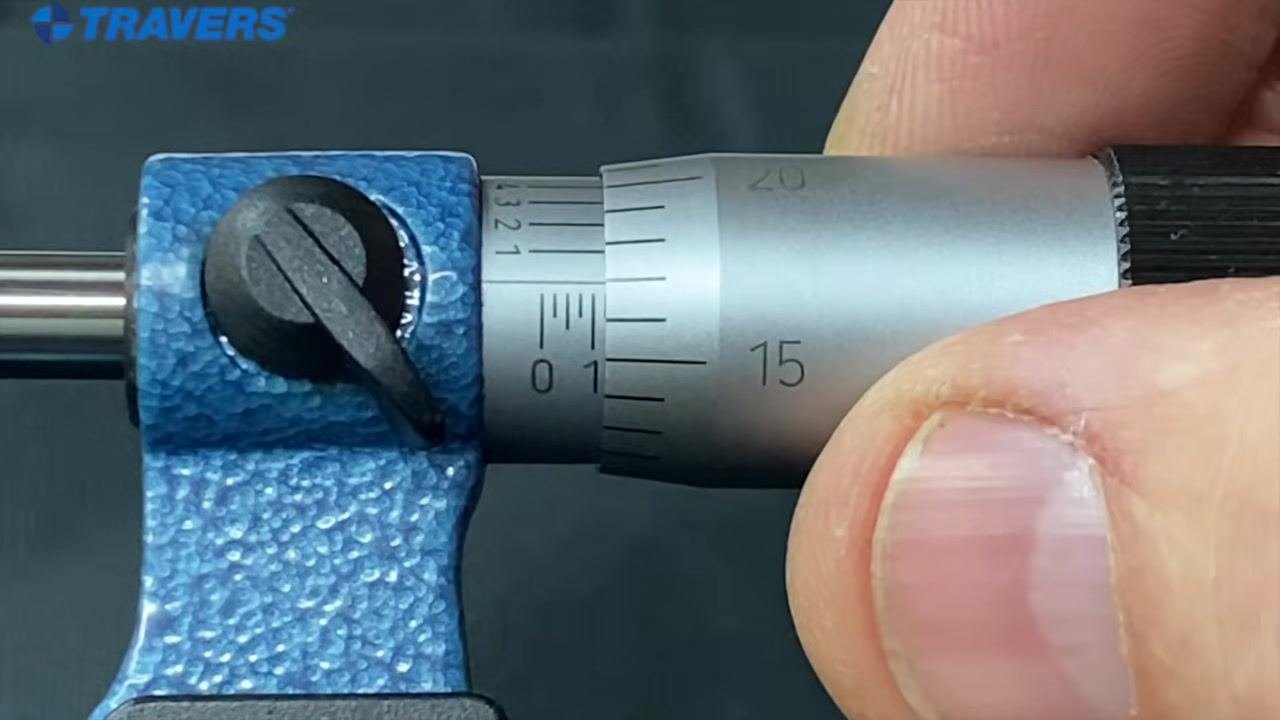 Micrometer with the "1" mark on the sleeve and the "17" on the thimble aligned with the reference line, indicating 0.117 inches.