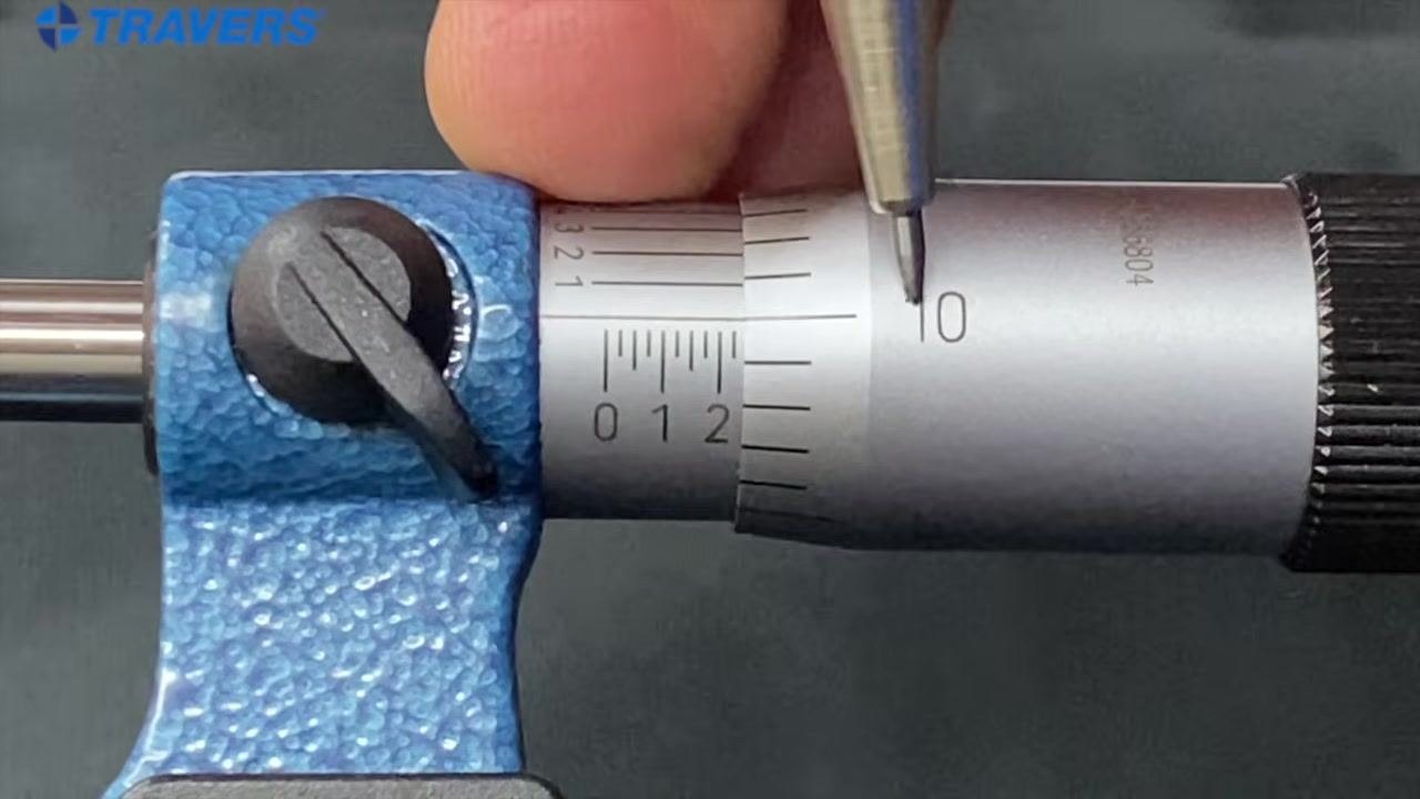 Micrometer with the "2" mark on the sleeve and the "35" on the thimble aligned with the reference line, indicating 0.235 inches.