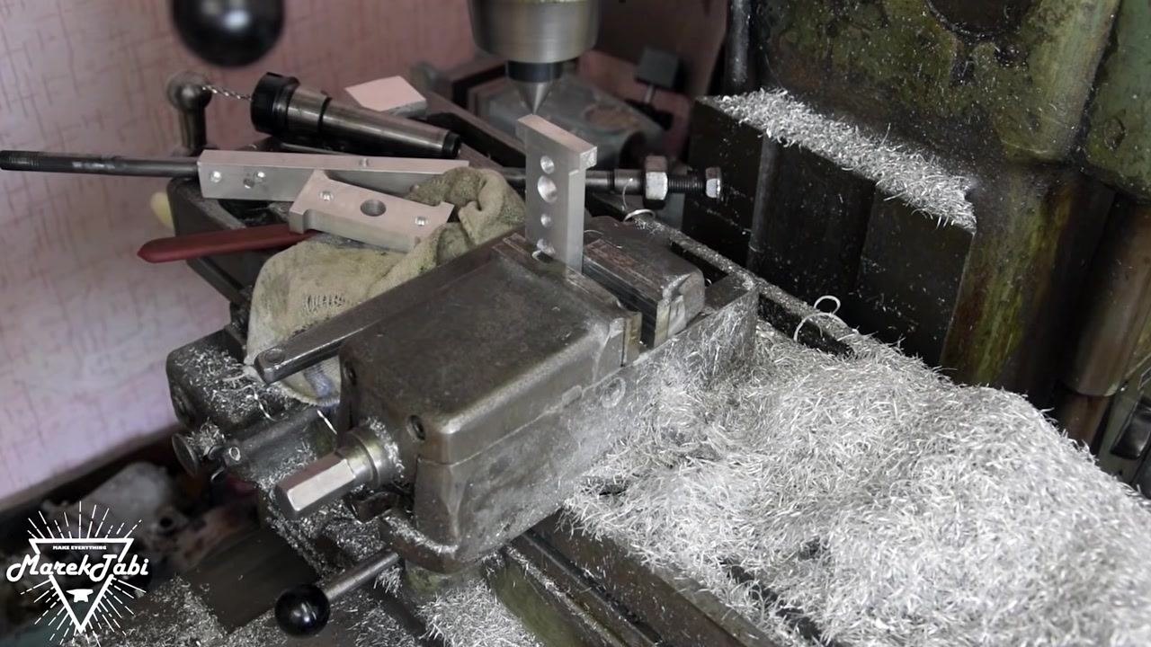 The workpiece remaining upright in the vise, with tools and metal shavings visible, indicating readiness for the next step or cleanup.