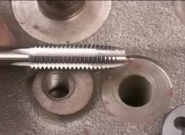 Cross-section of a threaded hole showing the unthreaded space at the bottom relative to the tap's taper