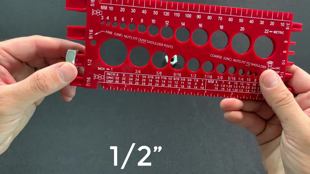 A nut fully inserted into the 1/2 inch hole of the gauge, confirming its size and thread type, with "1/2”" text overlaid.