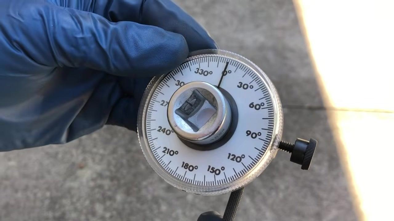 Gauge being zeroed, with the pointer aligned at 0 degrees and the retaining bar visible