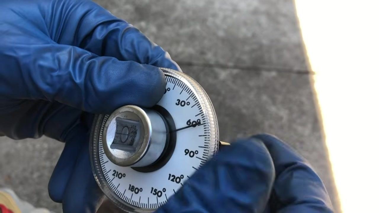 Gauge being removed, with the thumb screw visible for easy detachment