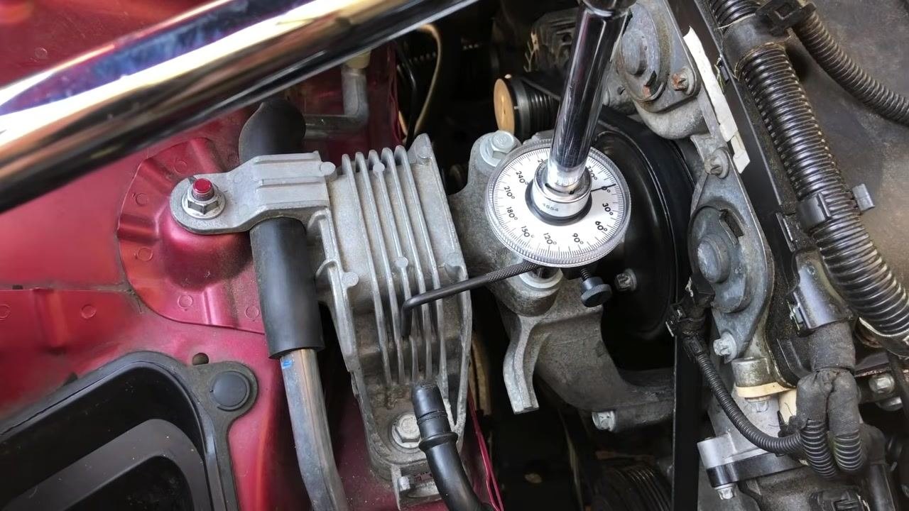 Engine bay with the torque angle gauge removed, showing the completed fastener and surrounding components