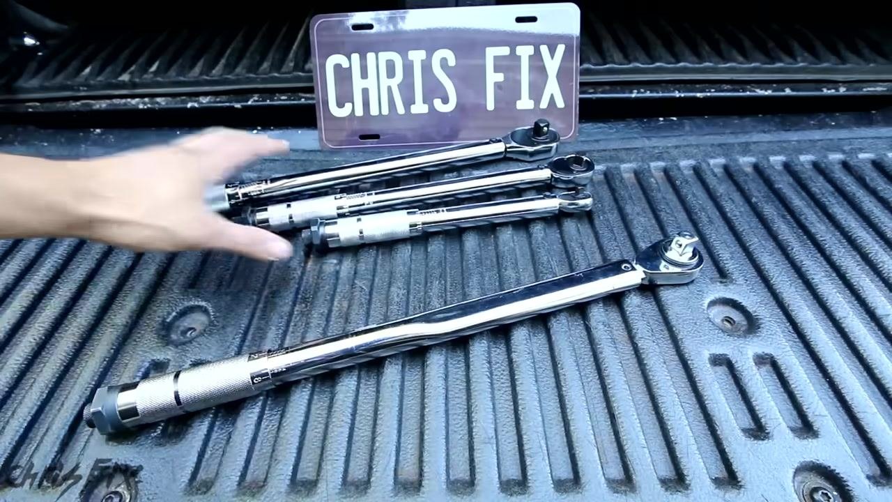A hand gesturing toward a set of torque wrenches laid out in a truck bed, with a "CHRIS FIX" plate in the background, summarizing the importance of proper care