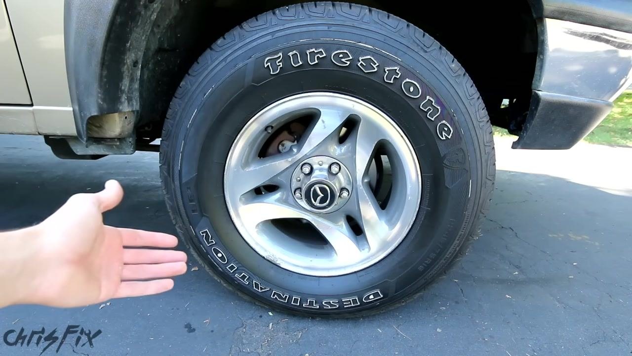 Close-up of a torque wrench scale showing "TORQUES FOOT POUNDS" with a finger pointing at the scale