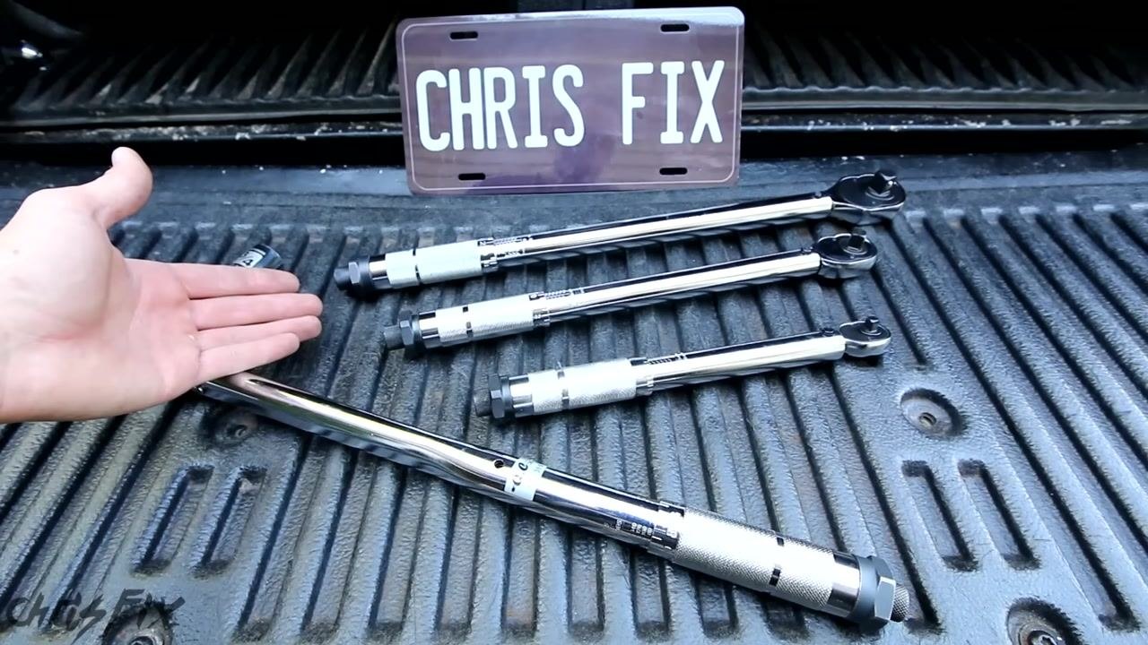 A hand gesturing toward four torque wrenches of different sizes laid out in a truck bed, with a "CHRIS FIX" plate in the background, indicating a discussion of tips and FAQs