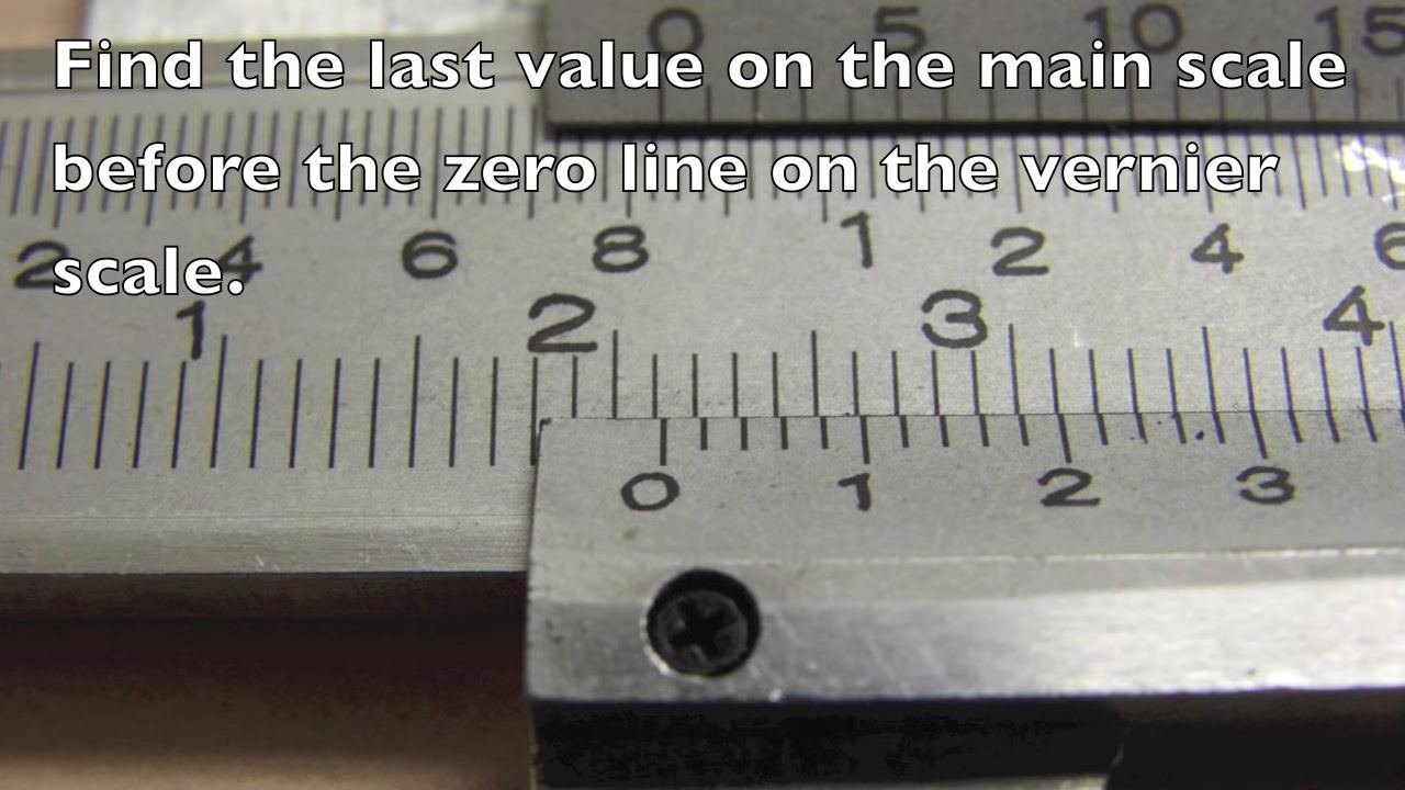 Close-up of the caliper scales with on-screen text: "Find the last value on the main scale before the zero line on the vernier scale."
