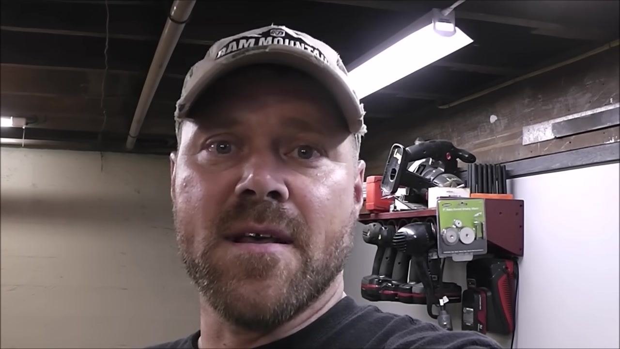 The narrator finishes the explanation, standing in a well-lit workshop with tools in the background.