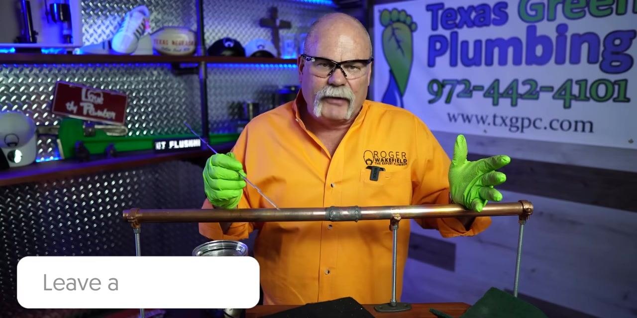 Screen transitions to blue overlay on the right, instructor still visible on the left holding the pipe and solder wire, signaling the end of the instructional segment.