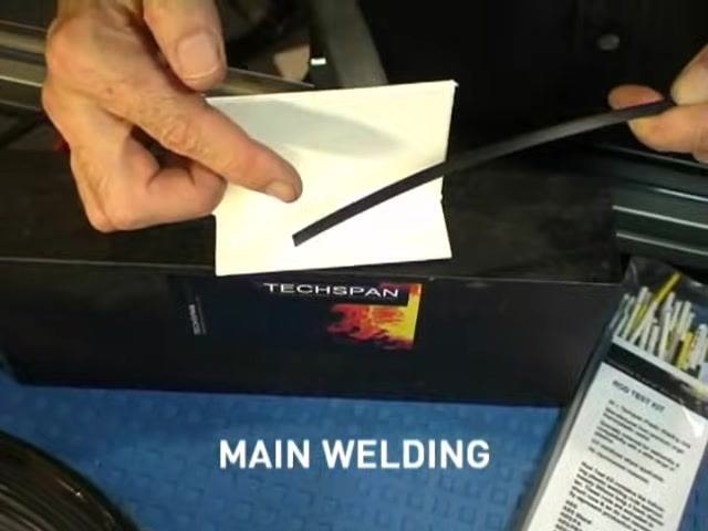 A person points to a selection of welding rods in a TECHSPAN rod test kit, with a list of materials visible on the packaging