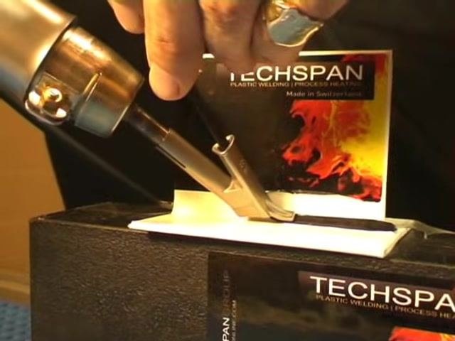Operator holds a TECHSPAN welding tool with a speed welding nozzle, applying downward pressure to a welding rod at the joint of two plastic pieces, with the words "SPEED WELDING" displayed on screen