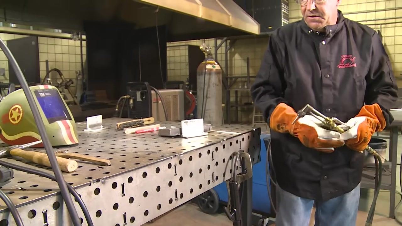 The aluminum workpiece after preheating and cleaning, showing a clean, shiny surface with visible tack welds.