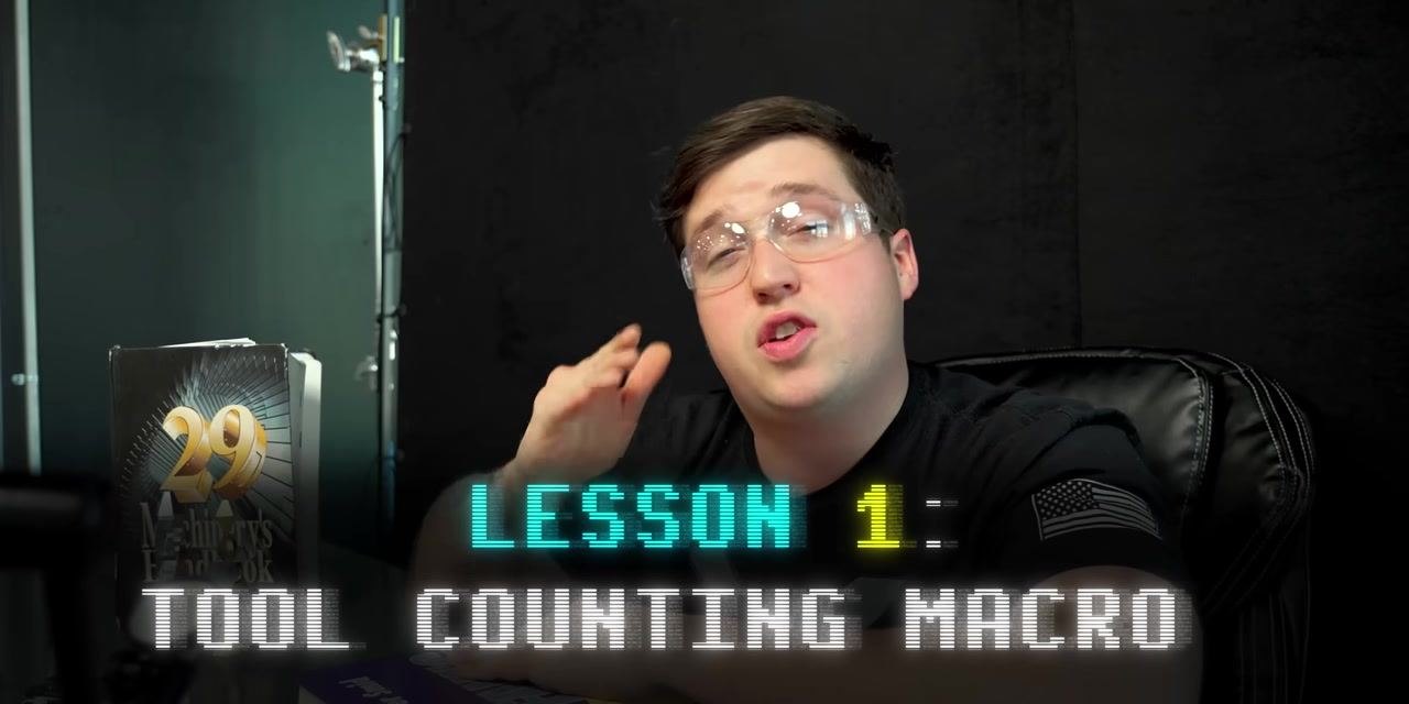 Instructor at a desk, introducing Lesson 1: Tool Counting Macro, with relevant books visible