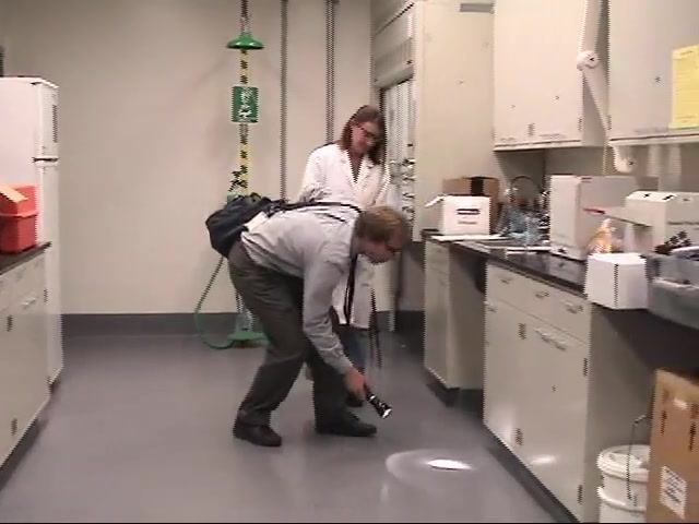 An EH&S staff member and a laboratory worker discuss next steps regarding waste pickup.
