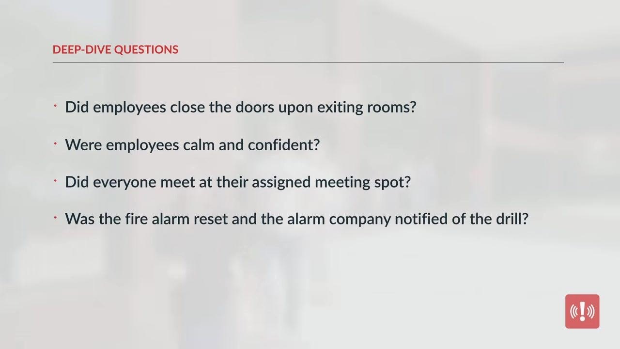 Four people seated around a conference table in a meeting room, discussing notes and observations shortly after the drill.