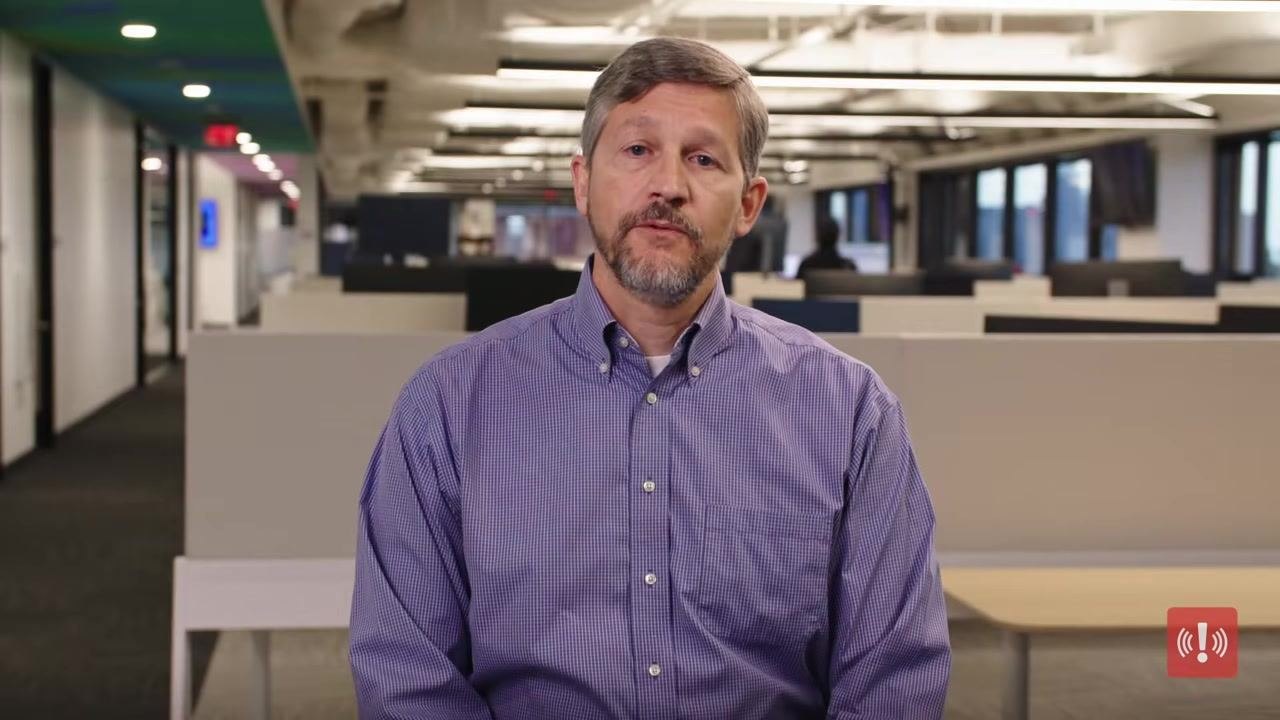Presenter Peter Steinfeld in an office, continuing to explain the importance of a comprehensive evacuation plan.