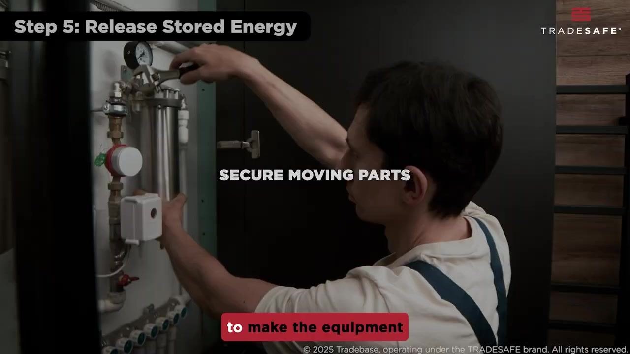 A hand operates a valve on a gas cylinder manifold with blue-handled valves and copper tubing.