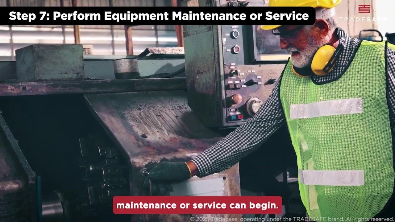 A worker in safety glasses presses a button on a control panel as a final check.