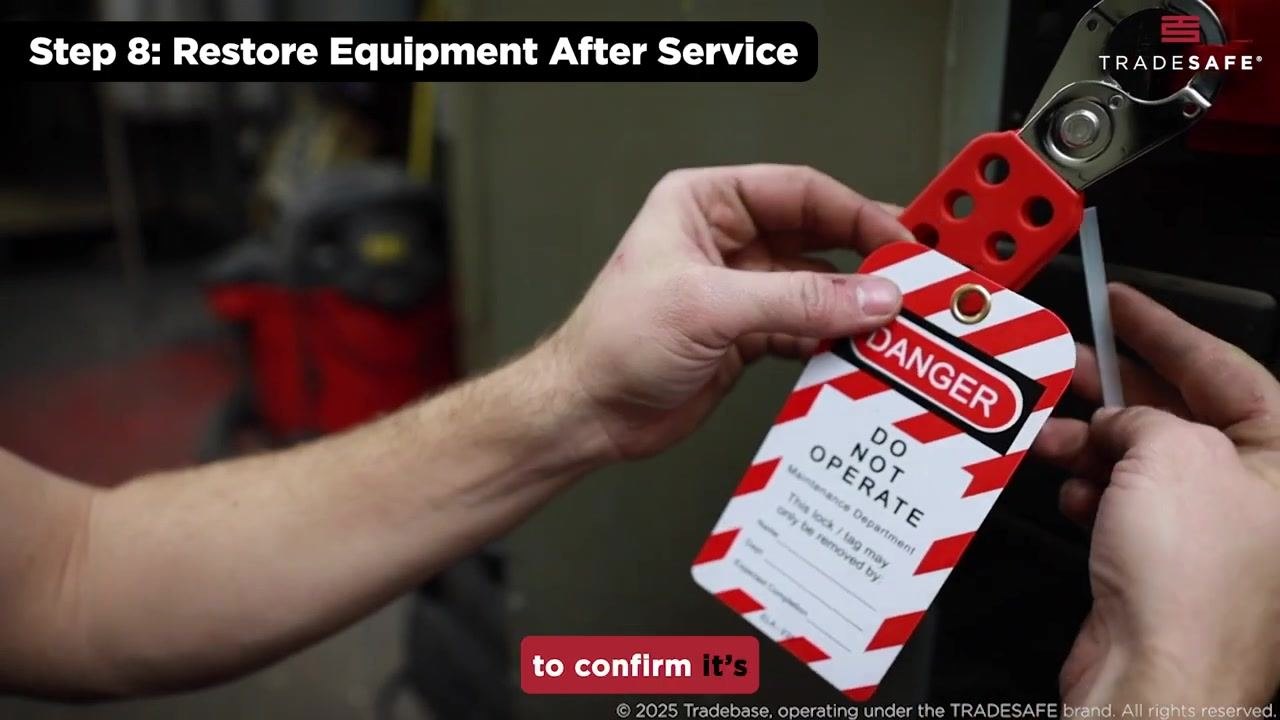 Hands hold a red lockout hasp and "DANGER DO NOT OPERATE" tag, confirming the identity of the employee before removal.