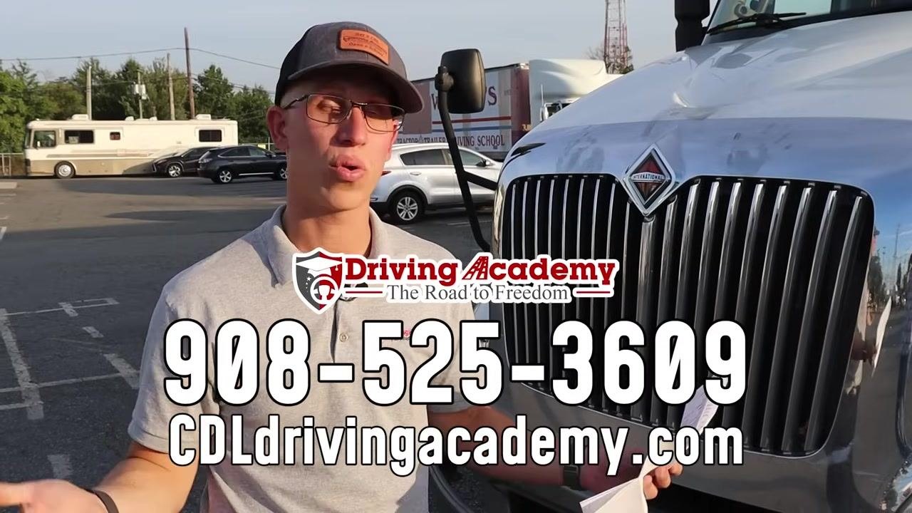 Instructor holding a printed checklist next to the front of a commercial truck, showing the importance of using the checklist correctly.