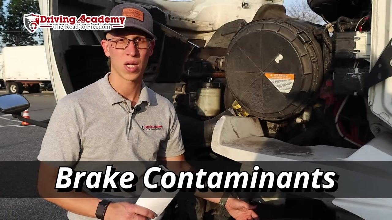 Instructor explaining the need to check for brake contaminants.
