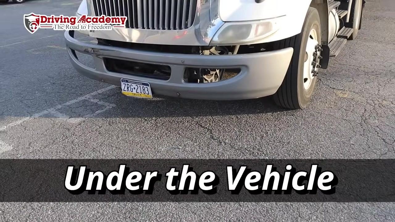 Close-up under the front of the truck showing no visible leaks or puddles on the ground.