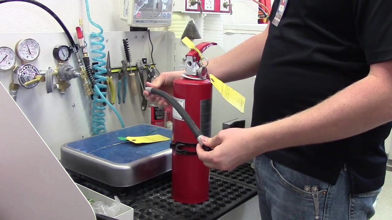 A person holding the detached hose, inspecting it for blockages and deformities.