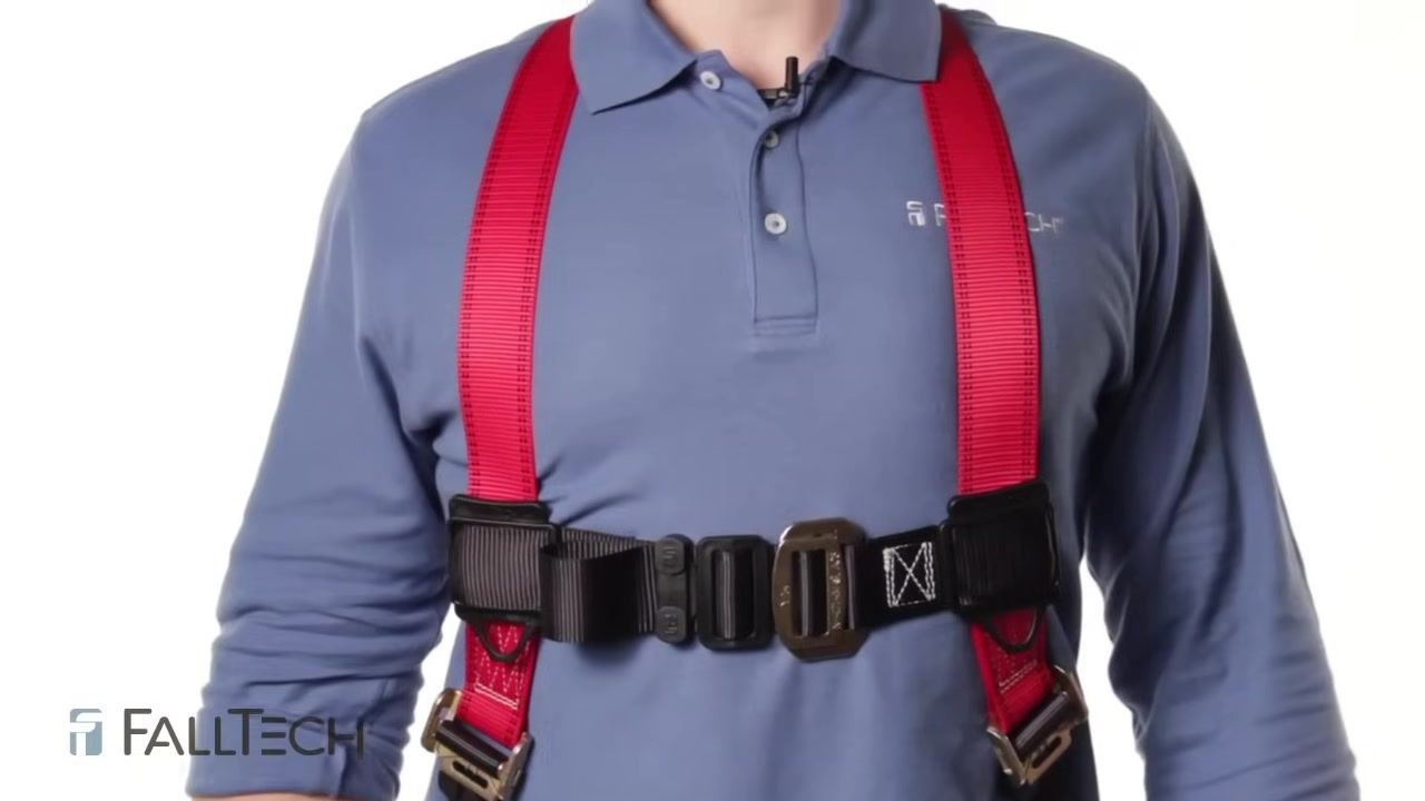Close-up of a person wearing a harness with the chest strap positioned correctly across the center of the chest