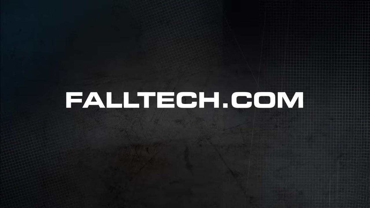 Person wearing a harness, illustrating proper storage and care with a clear view of the harness and FallTech branding