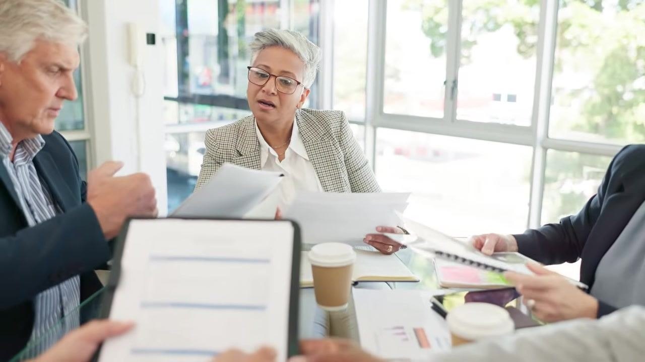 The safety trainer stands in an office environment, emphasizing the importance of knowing who to contact for more information about the emergency action plan.