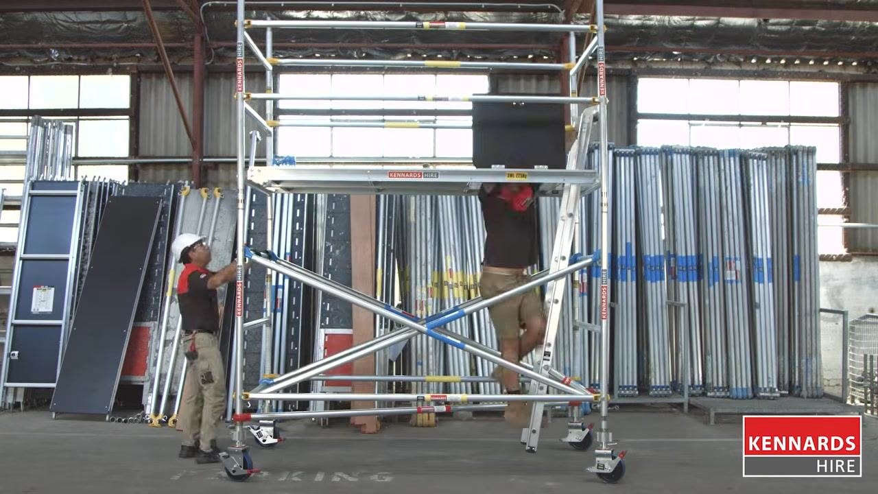 Fully assembled scaffold with equipment racks visible in the background, illustrating scaffold safety benefits