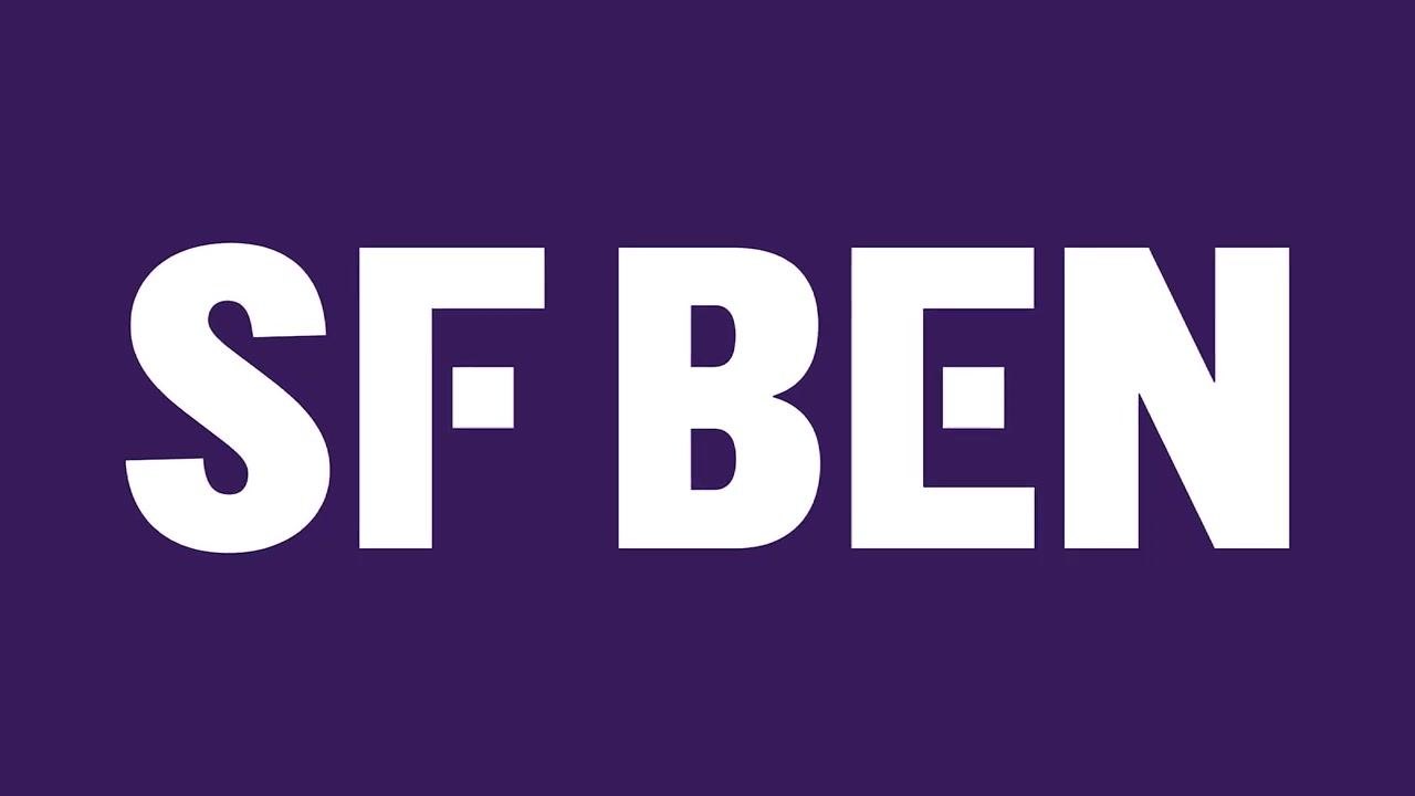 A person smiling and speaking into a microphone, with a dark background and the "SF BEN" logo in the lower right corner. The speaker is encouraging the extension of queues to other teams.