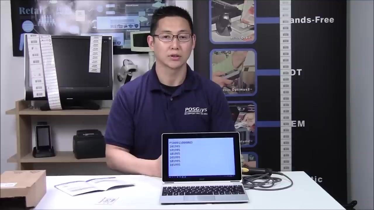 A person sitting at the table with the scanner, laptop, and quick start guide, concluding the demonstration in a retail or office setting with barcode equipment in the background.
