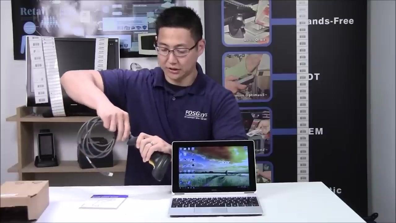 A person plugging the USB cable into the barcode scanner, demonstrating the connection process.