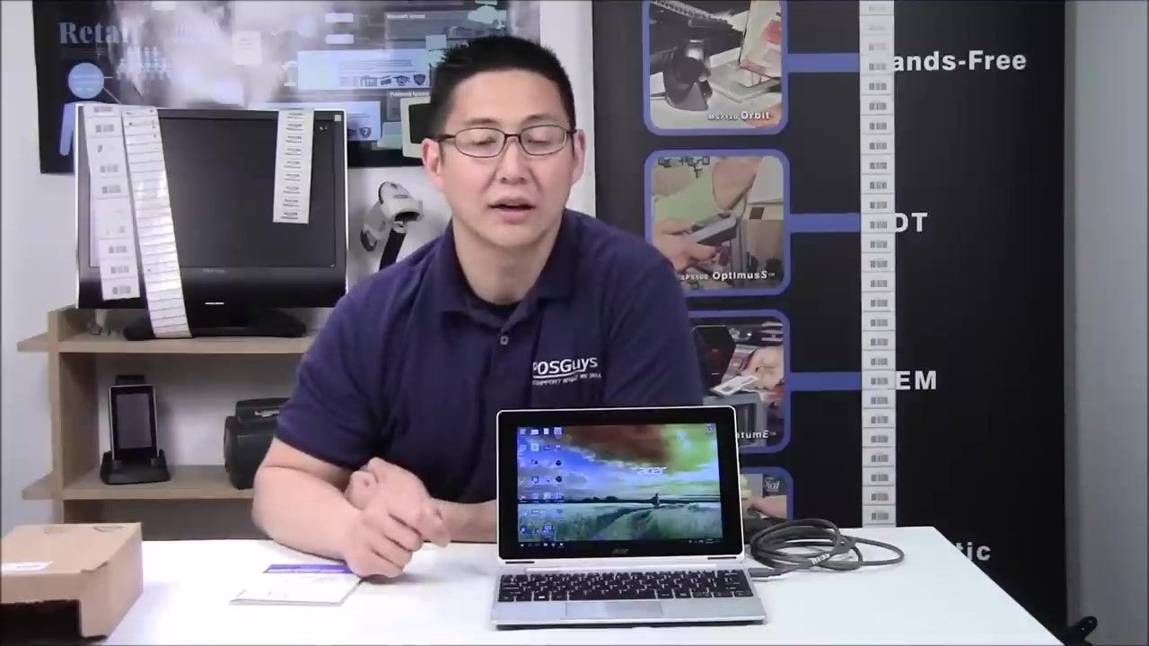 A person waiting for the computer to detect the scanner, with the scanner connected and the cable visible on the table.