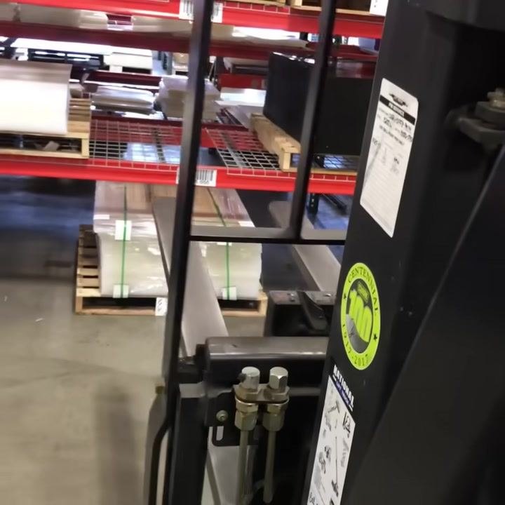 Forklift mast and fork carriage, showing the mechanism for side-to-side movement controlled by the third lever.