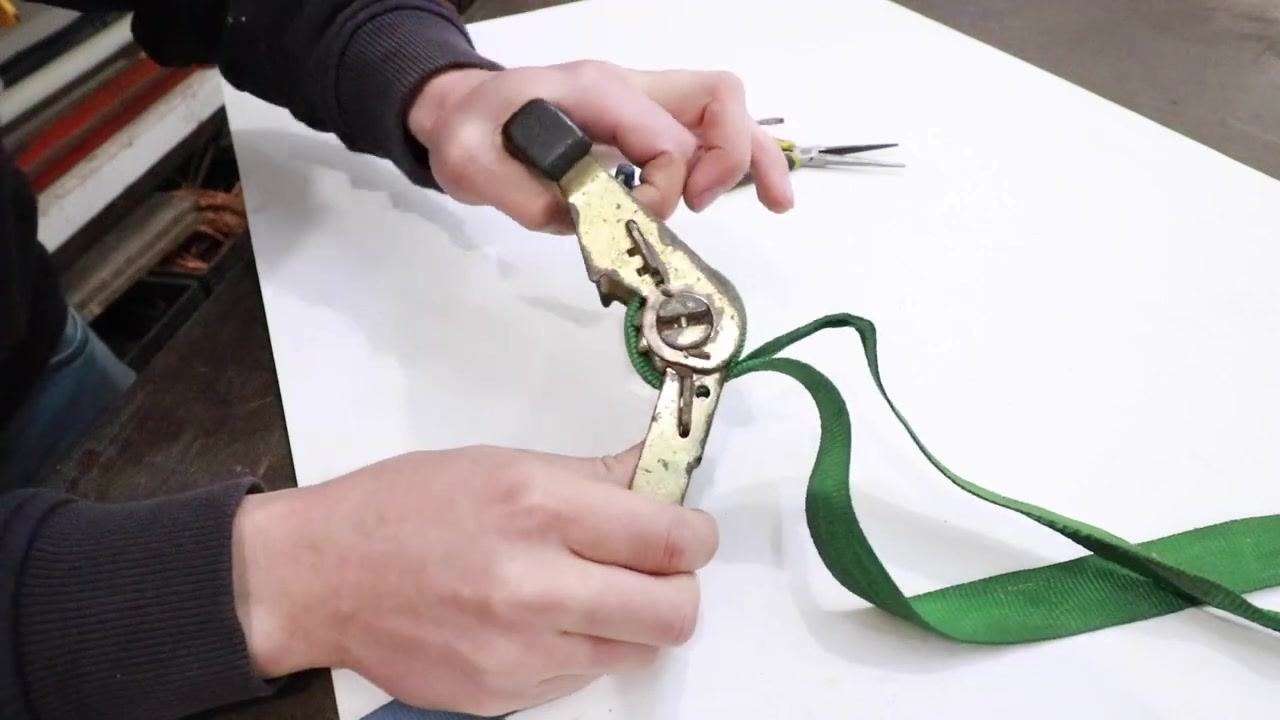 The ratchet handle fully straightened, showing the cam pushing the locking tab down.